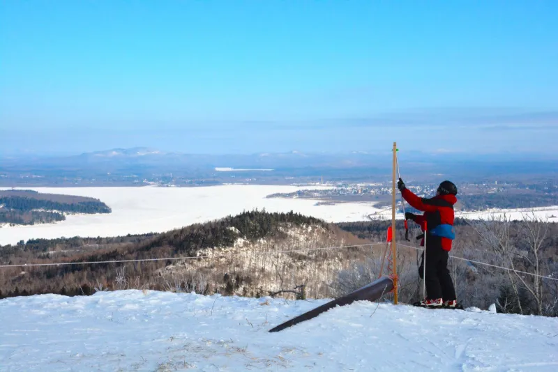 Mike Moore, a Big Tupper patroller, sets up a spot to hang the American Flag at the top of Chair 2