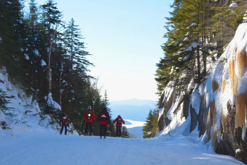 A team of patrollers heads down Palisades at the end of the day to sweep the trails of Chair 3.