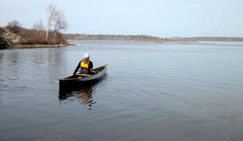 Anne enjoying a very early season paddle (Raquette River Outfitters photo)