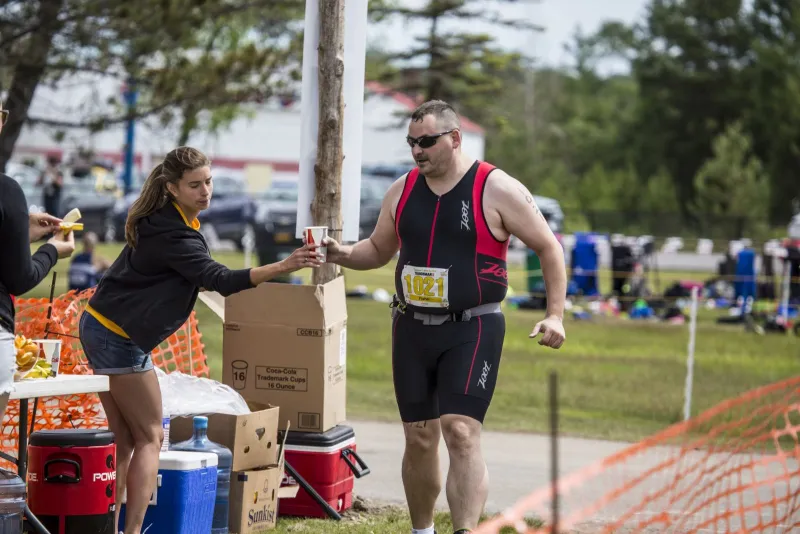 Volunteers provide support to Tinman athletes before, during, and after the race.