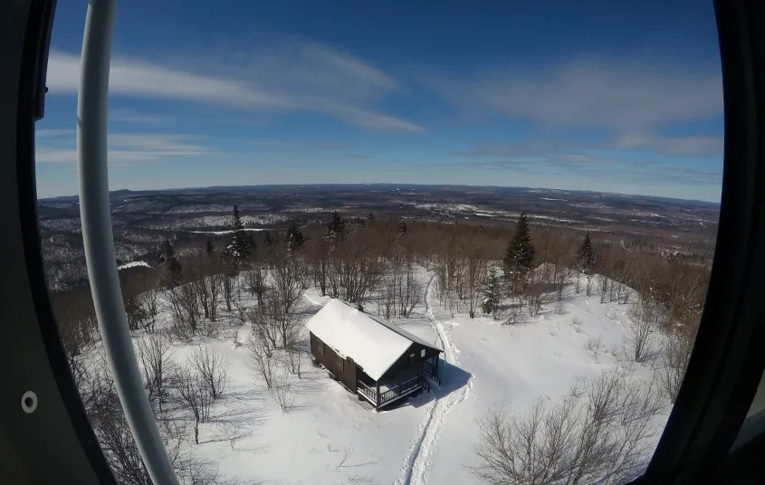 A view of an old firetower observers cabin in the winter