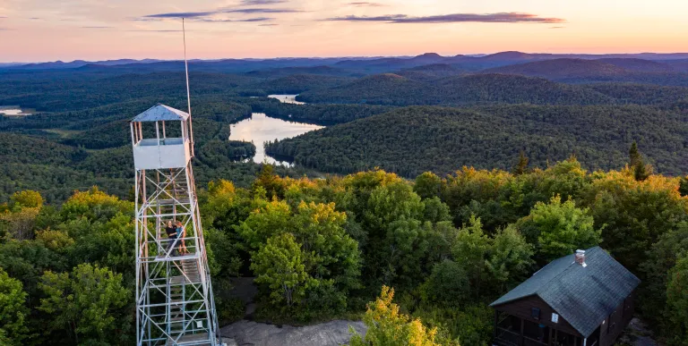 A firetower with the setting sun as a backdrop