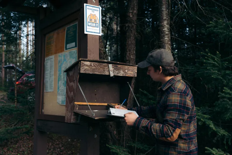 A paddler signs into a trail register
