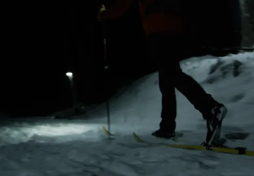 Skier on the trails at night in Tupper Lake