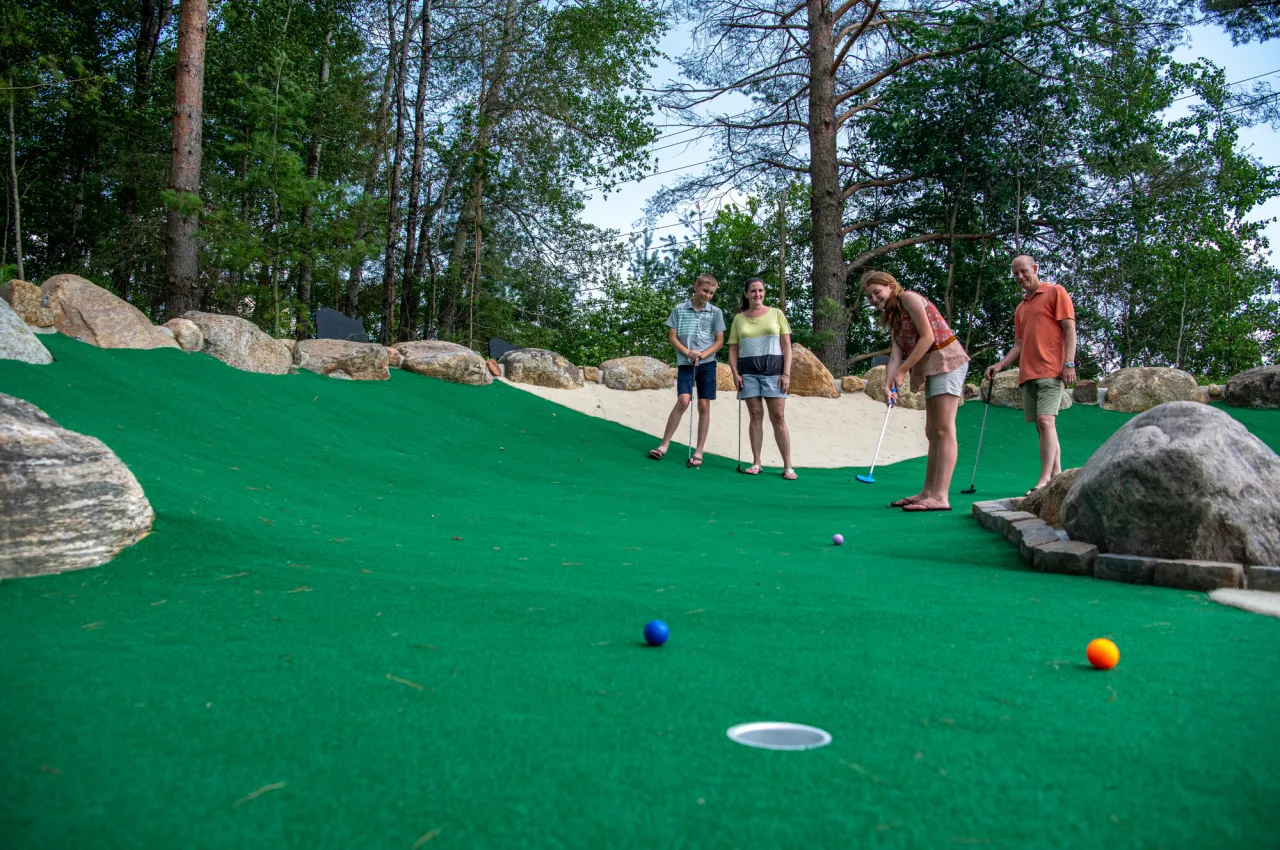 A family playing mini golf at Timberjaxx in Tupper Lake.