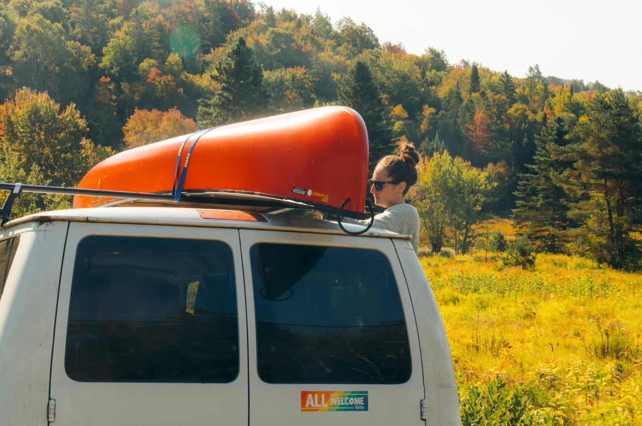 A woman getting a boat off her car.