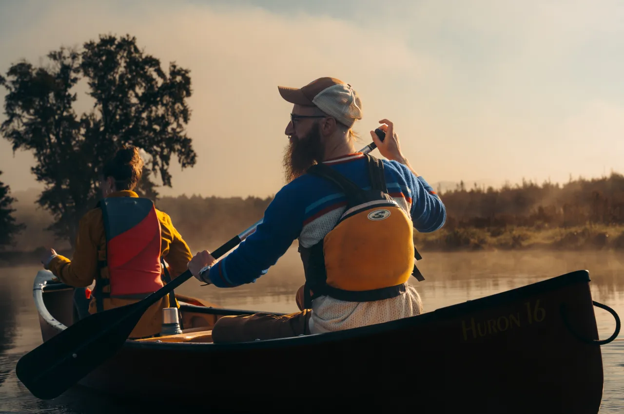 Two people paddling in a canoe.