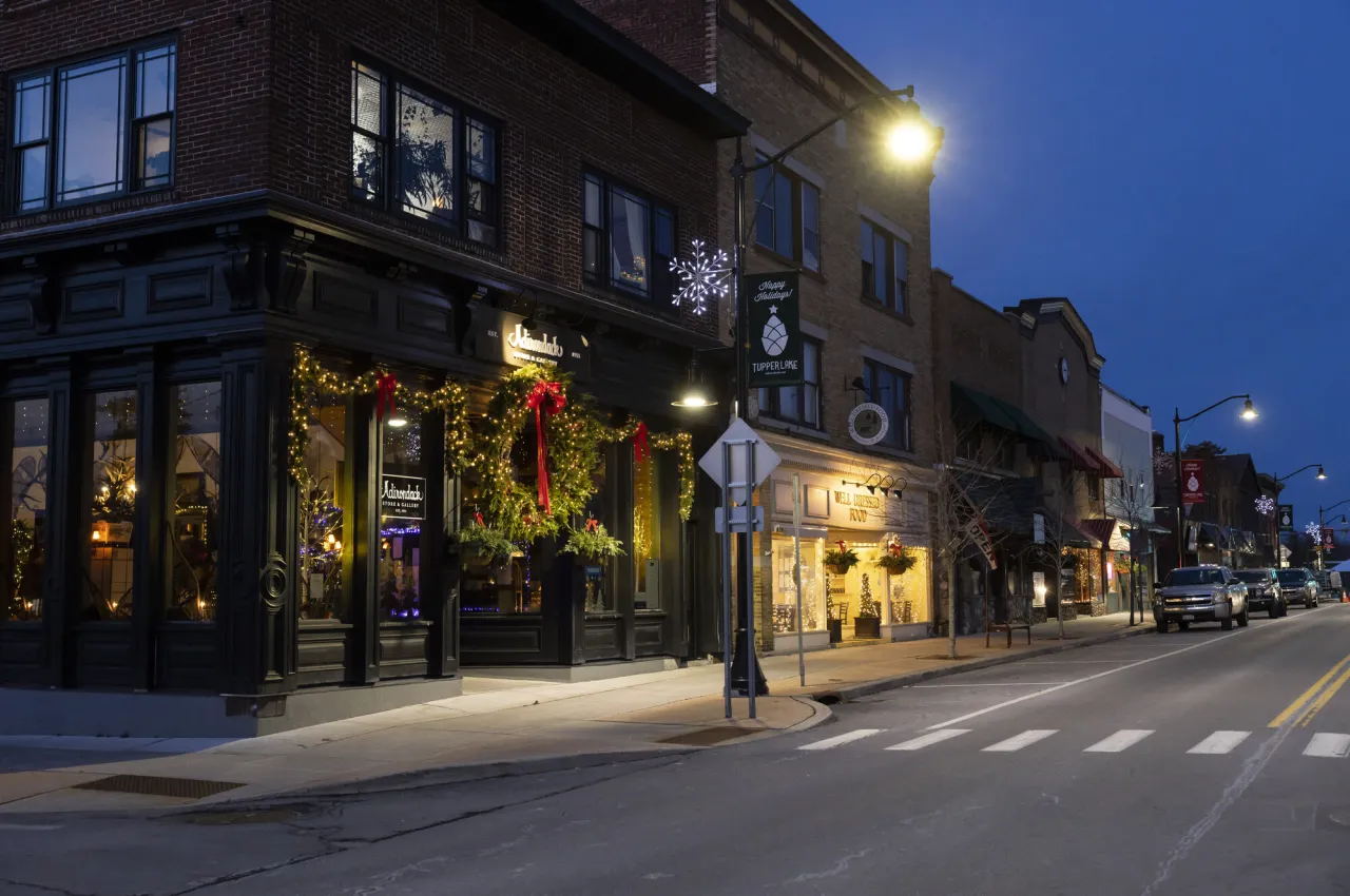 A downtown block of shops is festively lit and decorated for the December holidays.