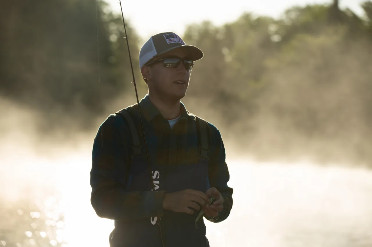 Guy fishing on a foggy spring morning in Tupper Lake