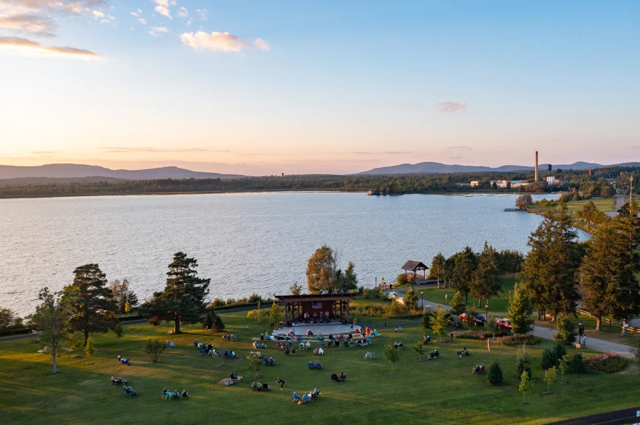 A lakeside park in summer with a bandshell and live music.