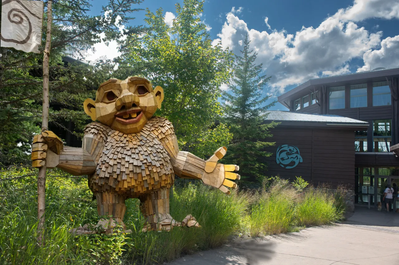 A troll stands in front of a science museum.