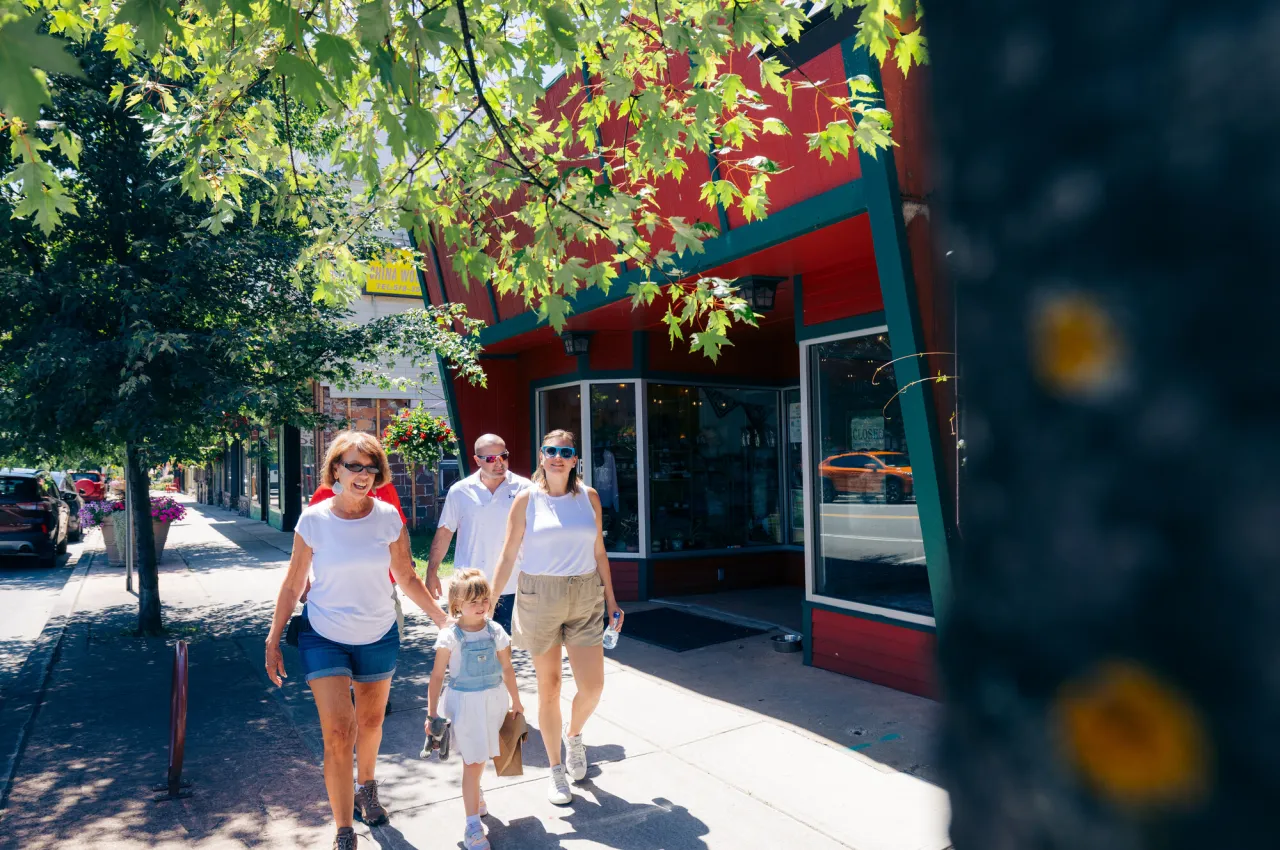 A family walks in a downtown of a small town.