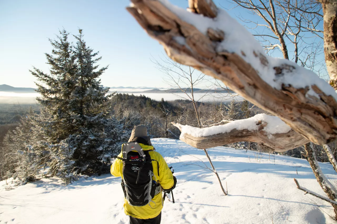 Snowshoer begins the decent down Coney Mountain in the Winter 