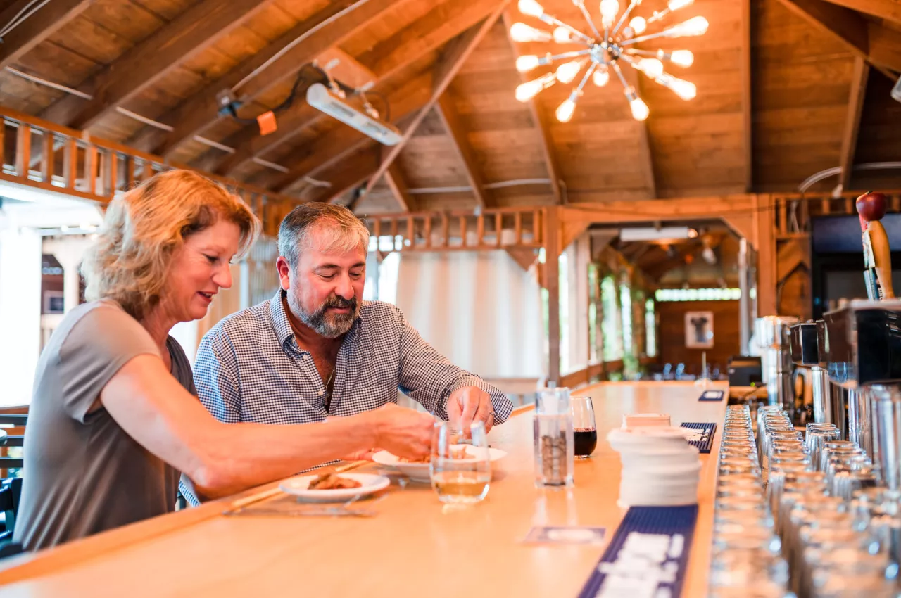 A couple sits together and shares an appetizer at a Tupper Lake restaurant