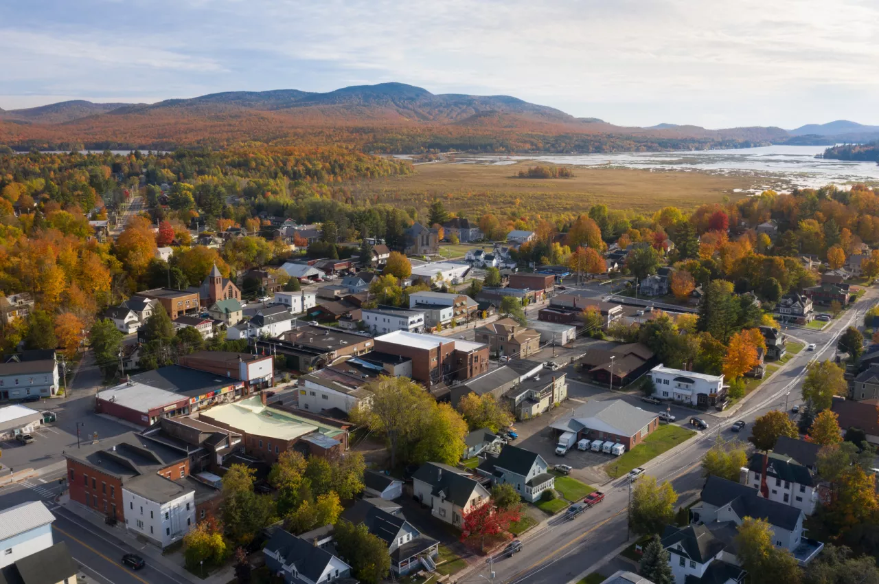 Aerial view of a small lakeside town during the fall season