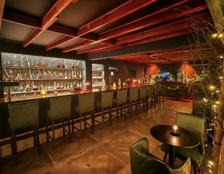 Warm wood and black leather chairs at the bar.