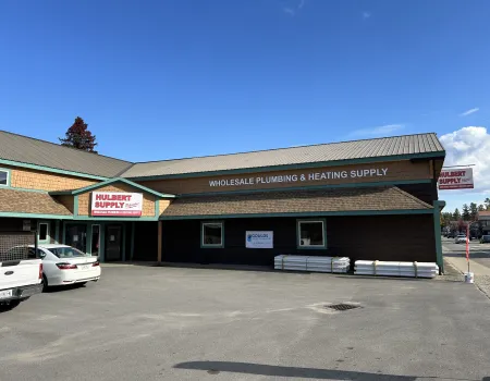 A brown building with shake roof.