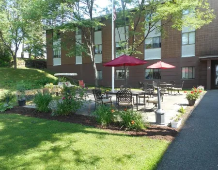 Patio area by grass at a brick complex