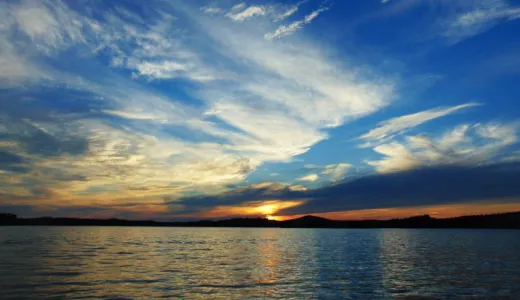 A sunset over a large lake