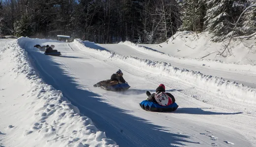 A few people tubing down the Mt Pisgah tubing runs