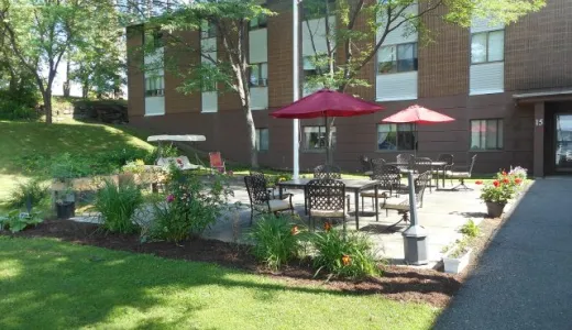 Patio area by grass at a brick complex