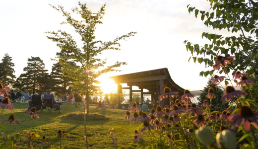 Crowd enjoys live music from the sunset stage bandshell as the sun sets