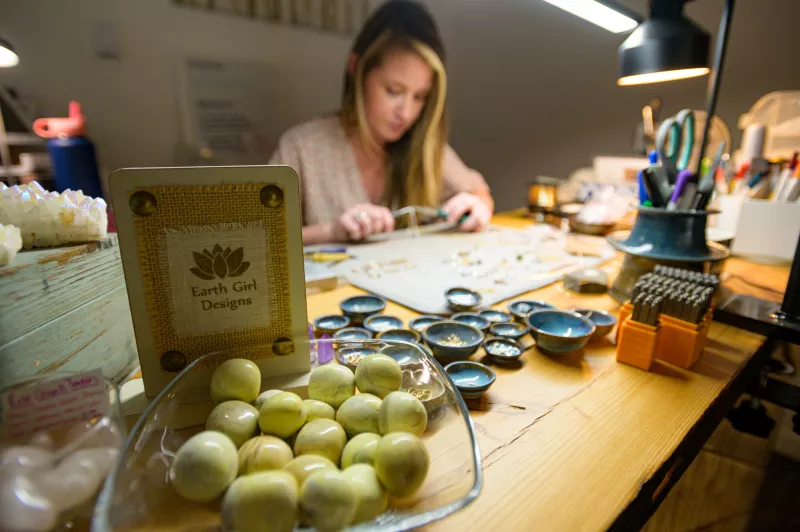 Rachel King crafts new jewelry at her work station.