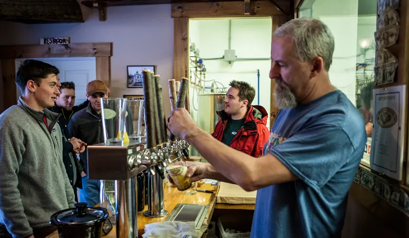 Mark serves up a fresh pint of Raquette River IPA at the brewery in Tupper Lake (ROOST / Shaun Ondak photo)
