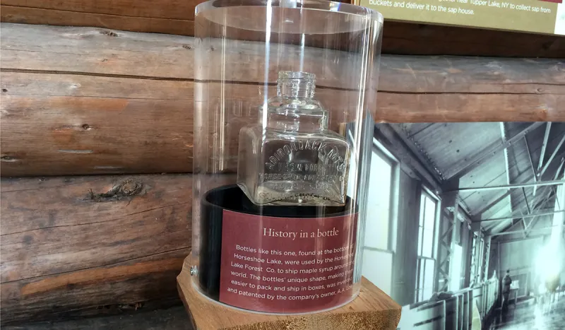 One of A.A. Low's square bottles used to ship maple syrup is now on display at The Wild Center. The bottle was fished out of Horseshoe Lake by one of "Tupper's Tappers."