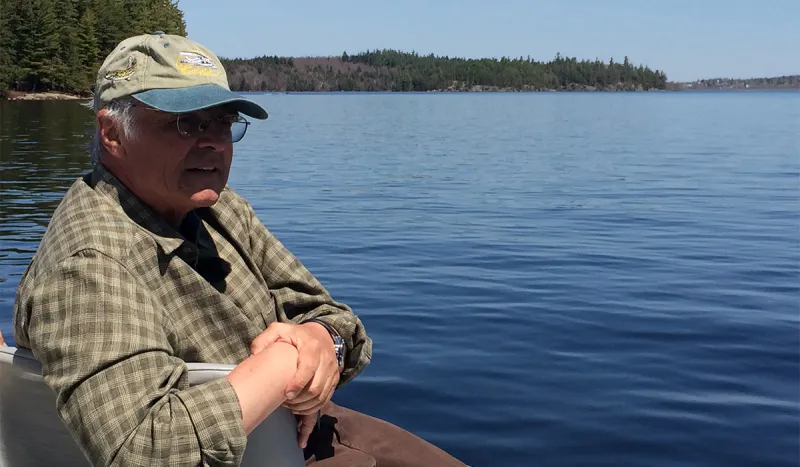 Television fishing personality, Don Meissner, enjoys the scenery from a fishing boat on Big Tupper Lake