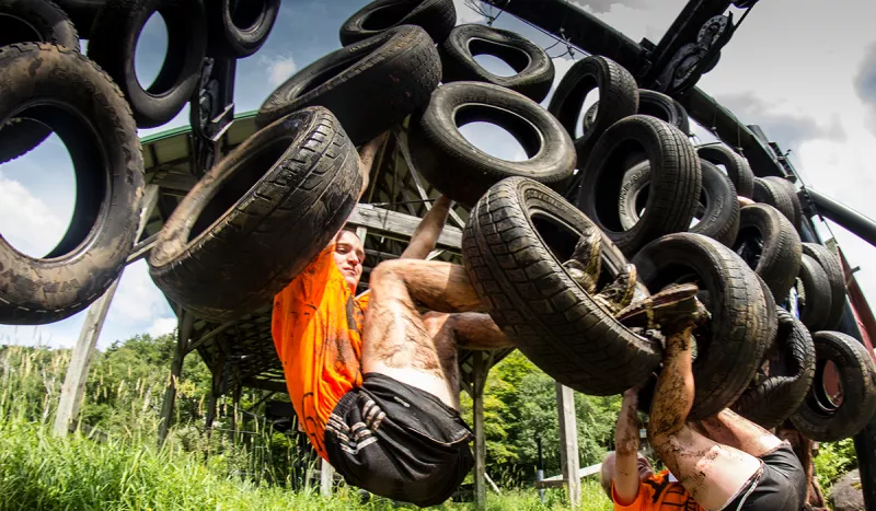 Tackling the tire wall at the 2014 Warrior Run (ROOST/Cam Willis photo)