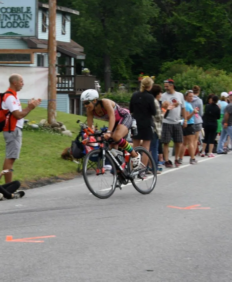 Amy Farrell rounds a bend in the bike portion of the Lake Placid Ironman with a smile on her face