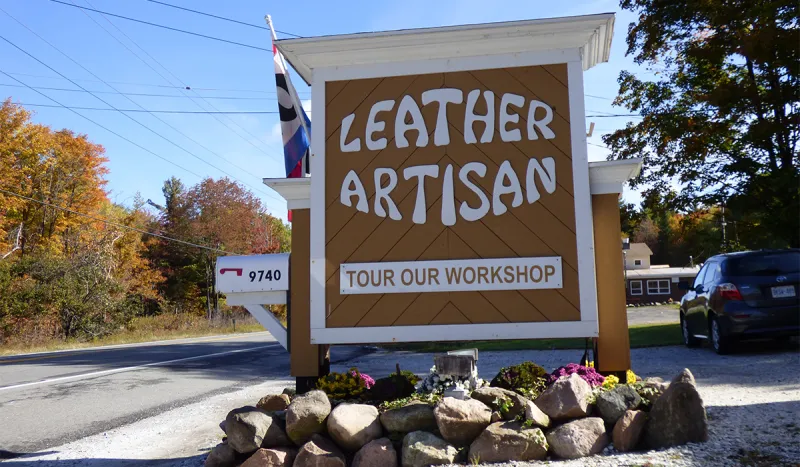 The sign at The Leather Artisan in Childwold, NY invites travelers to stop in and tour their workshop.