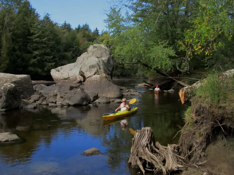 Jane and Anne paddling near the boulders at our destination - Raquette River Falls!