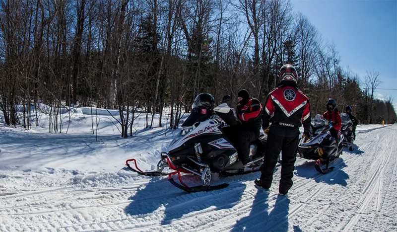 Trailside mapping - Riders take a moment to map out their route to the next cool snowmobile destination in the Tupper Lake region.