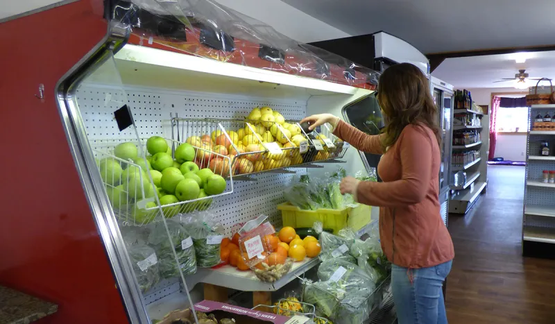 Kristen tends to the in-store produce selection at The Health Hub in Tupper Lake