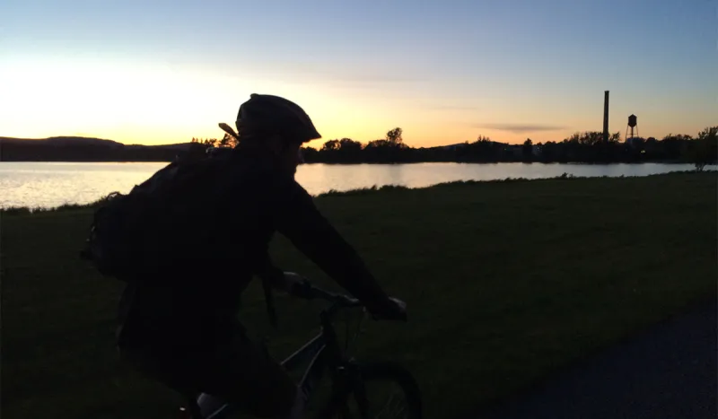 Biking at sunset along the Tupper Lake Waterfront Walkway