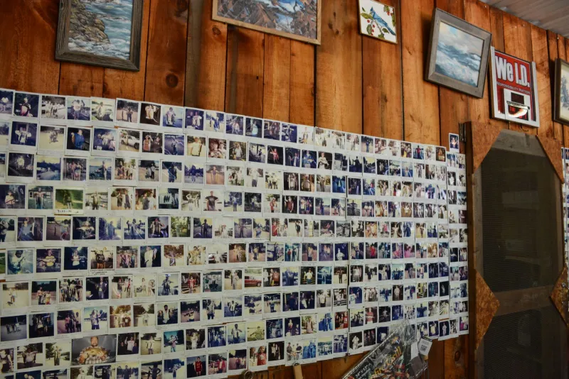 One of a few walls decorated with Polaroid photos of Blue Jay Campsite campers and friends and family of the Scottis with their proud catches of the day.
