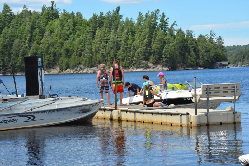 Mitch Harriman helps a few boating customers at the Blue Jay Campsite Marina.