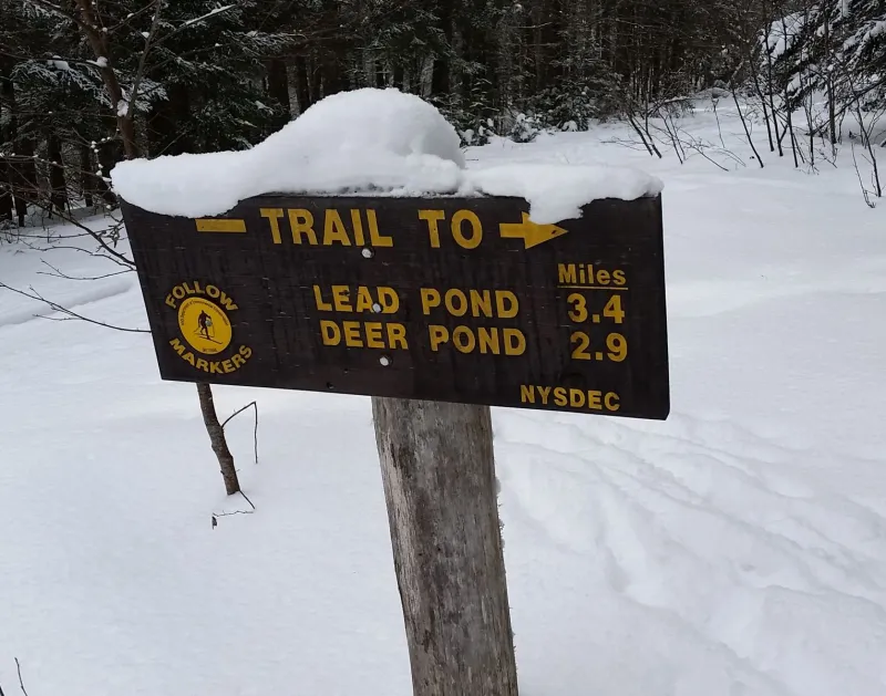 A DEC trail sign marks the way.