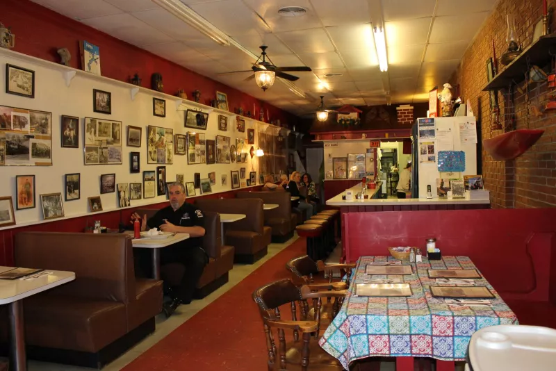 An old-fashioned family restaurant diner, with booths and a counter.