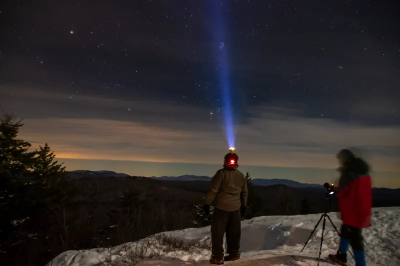 Two men stargazing as night falls on top of Coney Mountain.