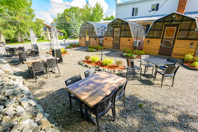 Outdoor dining offers tables as well as private dining greenhouses.