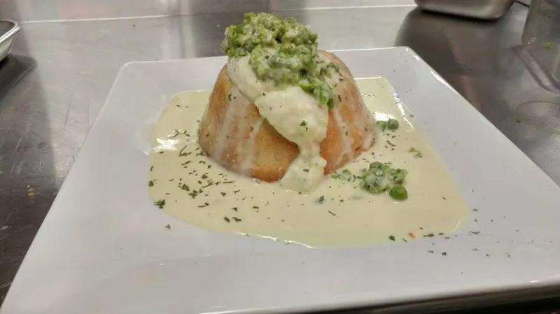 The delicious pot pie floater covered in cream sauce.