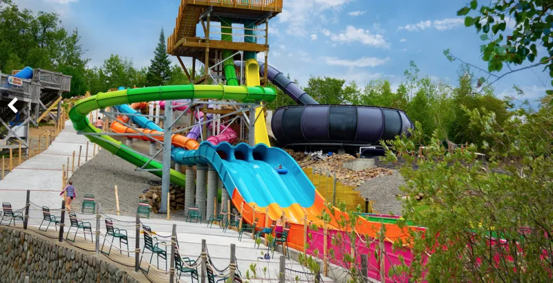 Colorful waterslides at an amusement park in summer.
