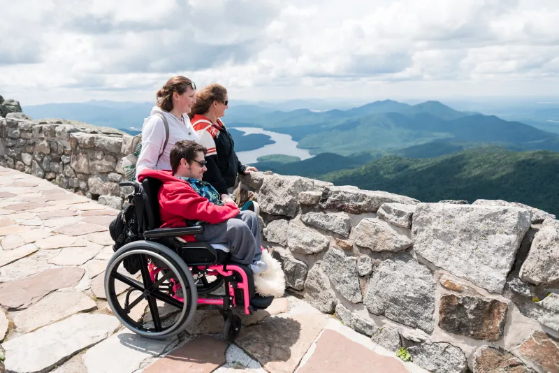 3 people take in the view from the summit of Whiteface Mountain