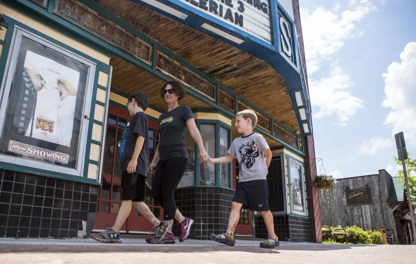 Family walks past the Adriondack State Theater in Tupper Lake