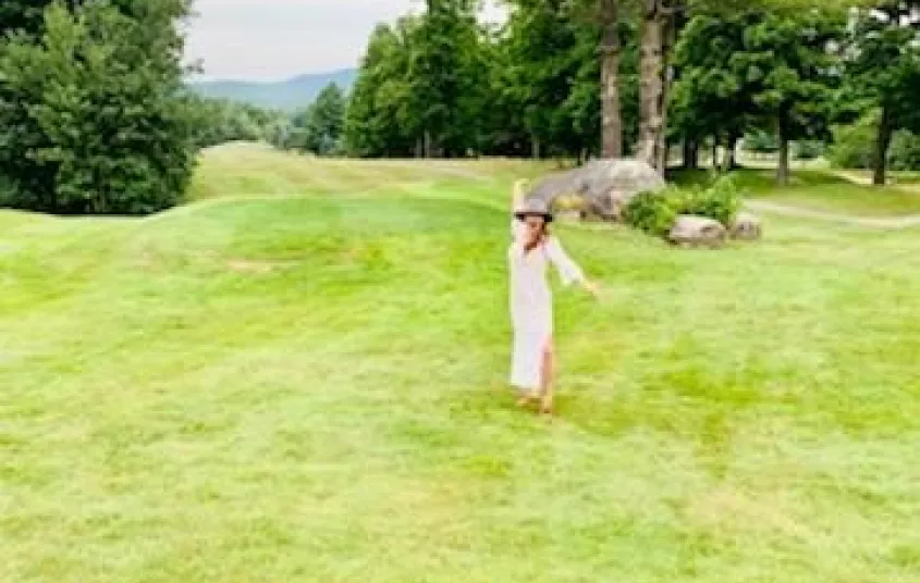 A person frolicking in a meadow