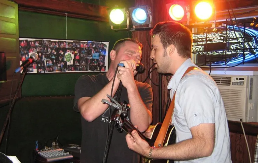 Band performing with singer and guitar.