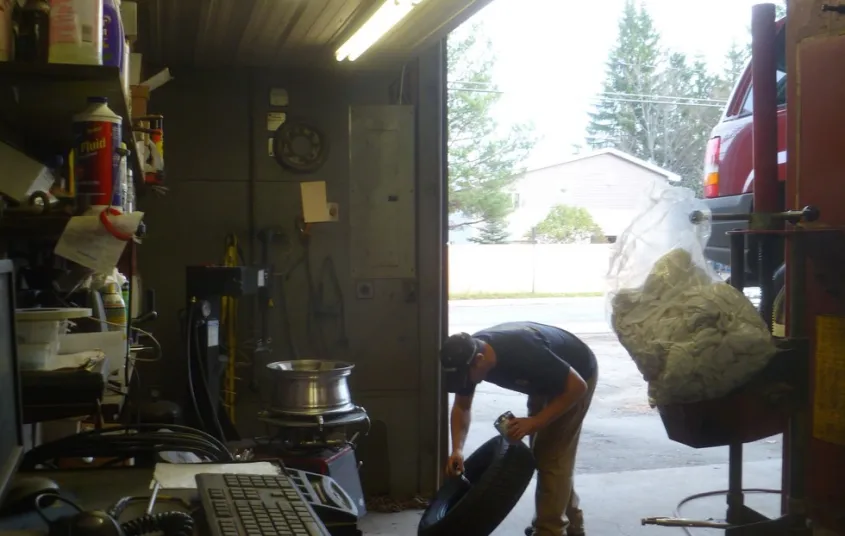 A person moves a tire at Counters Garage and towing.